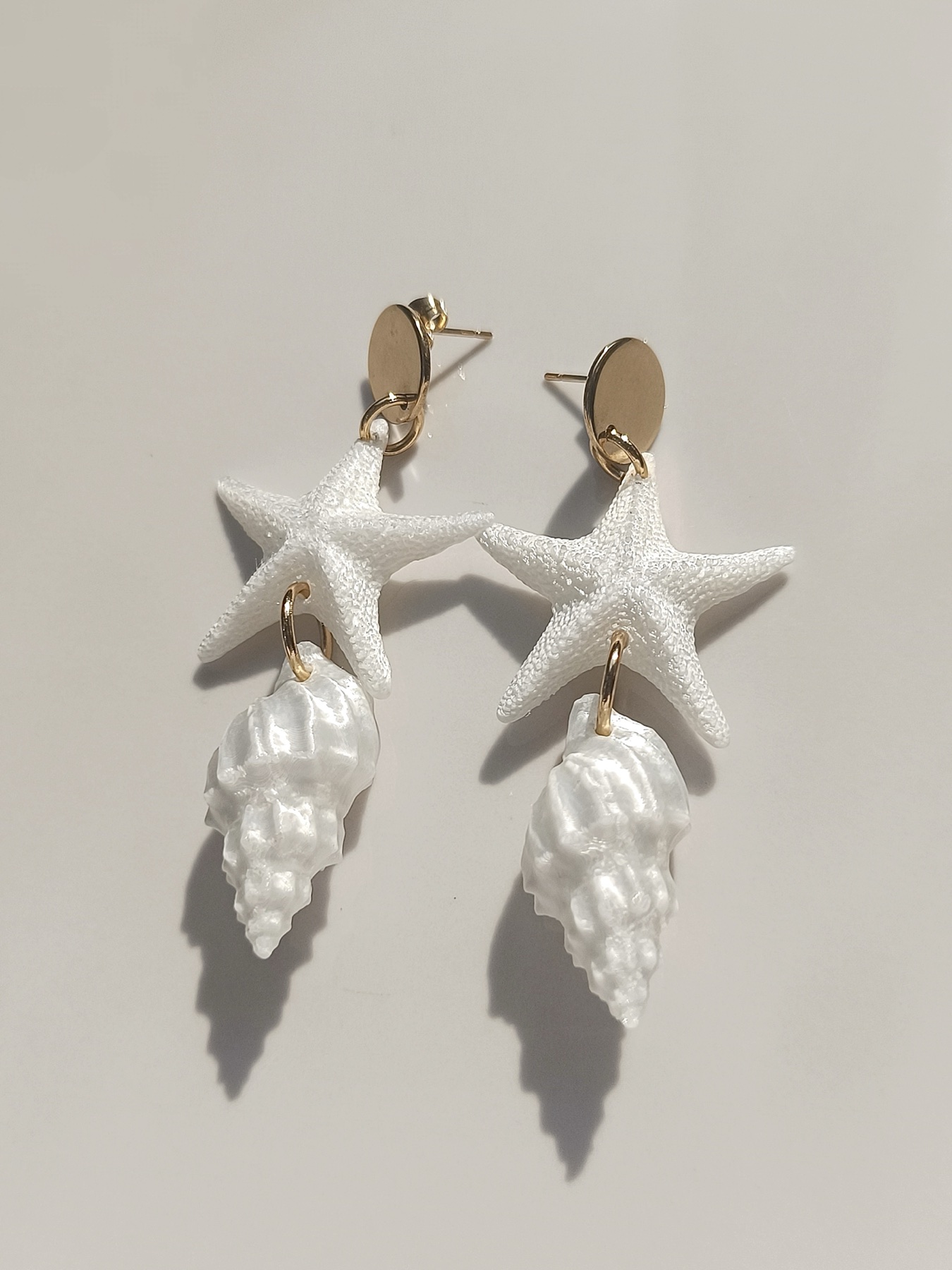White sea star and shell-inspired earrings